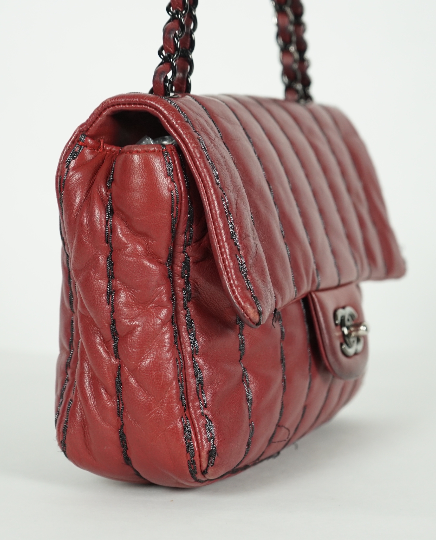 A Chanel Classic Jumbo Flap burgundy lambskin quilted shoulder bag, with pinstripe stitching, width 25cm, height 18cm, overall height 48cm, depth 6cm, Please note this lot attracts an additional import tax of 20% on the